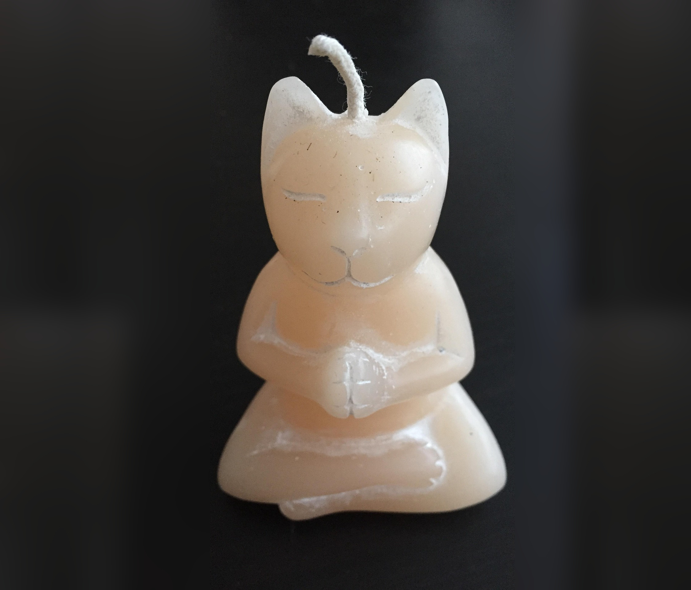 Lit candle in an amber vessel